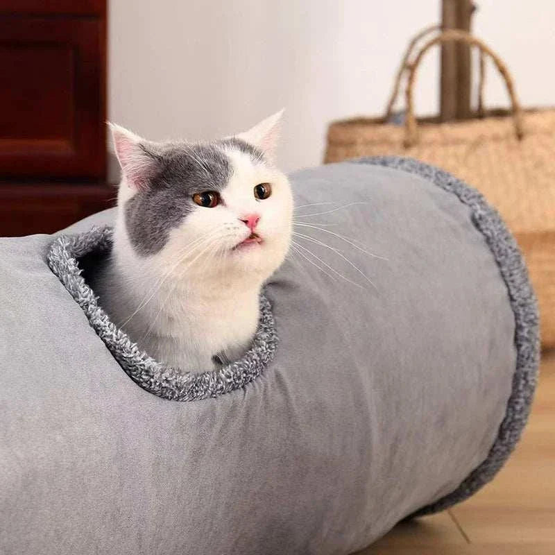 Collapsible cat tunnel with faux fur exterior, hanging ball, and extendable maze for interactive play and cozy hiding.